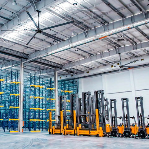 Heavy Duty 16Ft Hvls Industrial Ceiling Fan With 208 240V Three Phase powers large warehouse with forklifts and shelving.