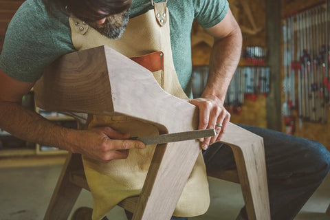 Pro Grade Six Inch Warding Hand Rasp Featuring Soft Touch Grip Handle being used on wood for fine shaping in a workshop.