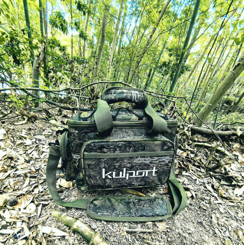 Versatile Fishing Tackle Bag With Non Slip Shoulder Strap For Freshwater And Saltwater Holds Four 3600 And One 3500 Tackle Boxes Medium Size Water Resistant 600D Ripstop Multiple Pockets Lures And Tools in a forest setting.