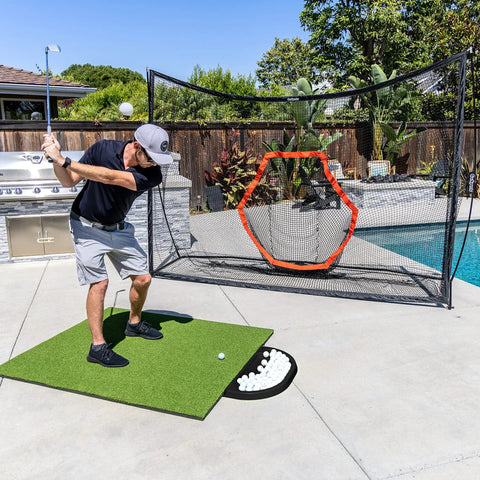 Man practicing golf swing with All Weather Golf Ball Tray For Hitting Mats, 70 Ball Capacity, in backyard setup, durable black