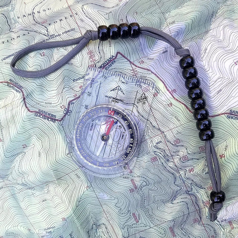 Pace Count Beads For Land Navigation Kit with nylon cord and compass on topographic map, Trail Ready Counter Beads For Hiking And Orienteering