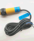 Photoelectric Sensor Switch E3F-DS30C4 with 300mm sensing distance and 18mm thread, shown with connecting wires