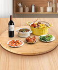 26 Inch Bamboo Large Lazy Susan for Dining Table with dishes and wine bottle, showcasing natural bamboo turntable top and smooth rotation.