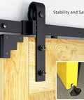 Close-up of wood slab door on 10 FT Double Sliding Barn Door Hardware Track Kit with J Shape Hanger, safety features shown.