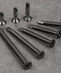 Collection of 250pcs #8 x 1-1/4 Inch Flat Head Self Tapping Sheet Metal Screws Black Stainless Steel on gray surface
