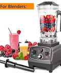 High-powered blender with fruit smoothies and cup with berries.