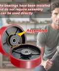 Pallet jack steering wheels set 7 x 2 inch with axle, red polyurethane tread on steel, bearings installed, mechanic with wrench.