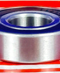 Side view of S6204-2RS Hybrid Ceramic Bearing 20x47x14mm ABEC-5 with stainless steel rings and rubber seals displayed on table.