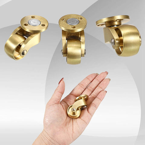 Hand holding 4PCS Universal Brass Stem Casters 1 Inch Furniture Caster Wheels, showcasing heavy-duty swivel design and solid metal construction.