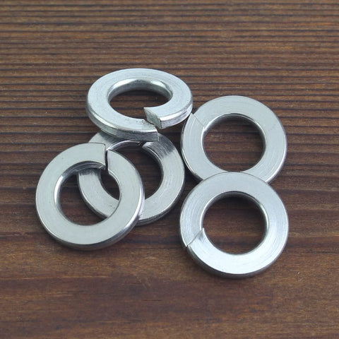 Five 10# stainless steel split lock washers for screws and bolts on wood surface